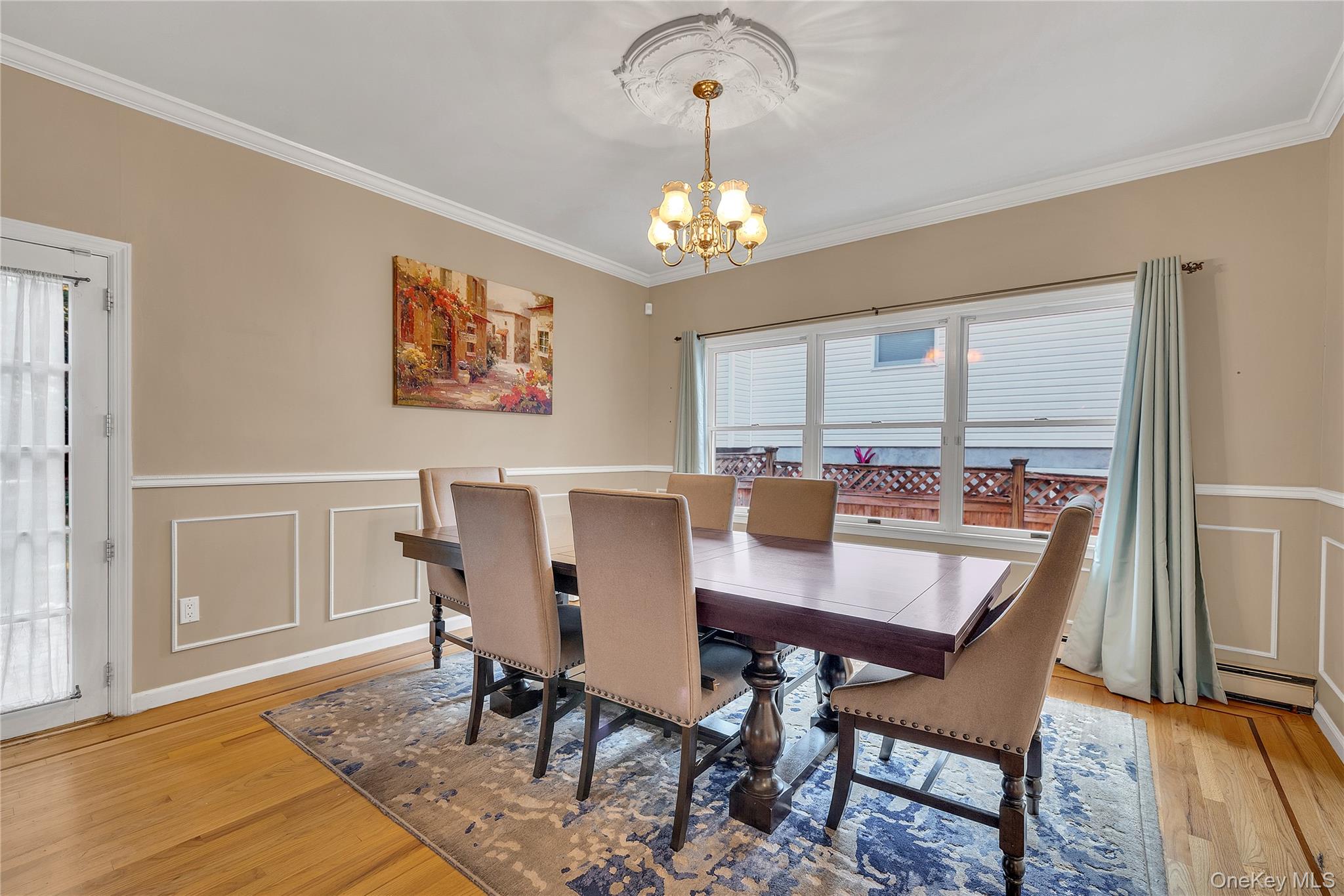 124 Fleets Cove Road Huntington, NY 11743 - Photo 10 of 35 a view of a dining room with furniture window and wooden floor