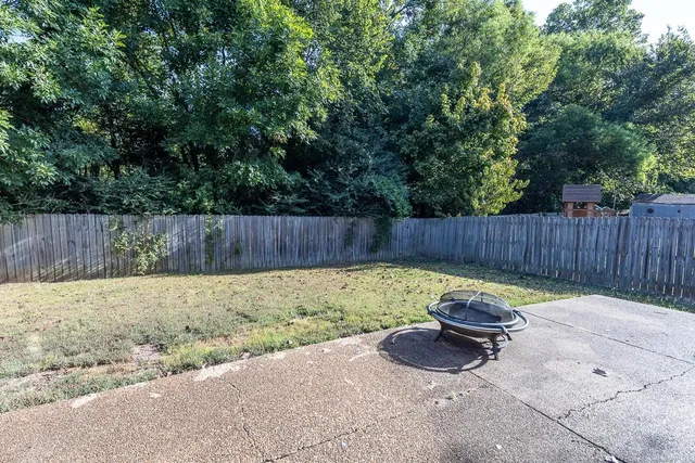 a view of a backyard with a small cabin and a chair