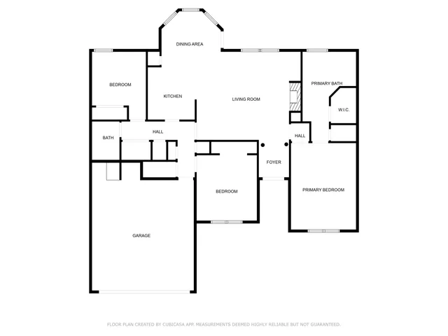 a kitchen with stainless steel appliances a dining table chairs and cabinets