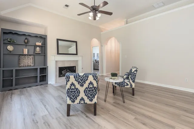 a living room with furniture a fireplace and a flat screen tv