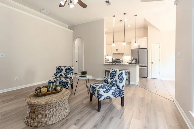 a living room with furniture and a chandelier