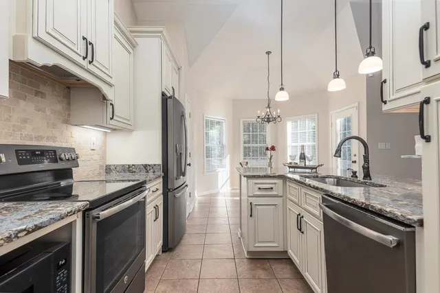 a kitchen with a sink stove and cabinets