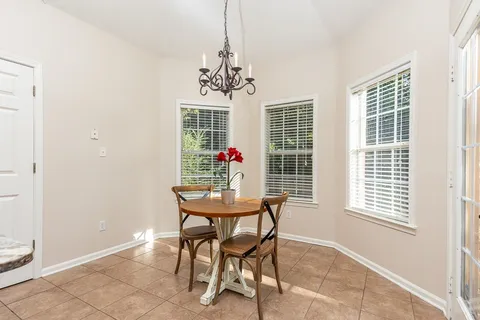 a view of a dining room with furniture and window