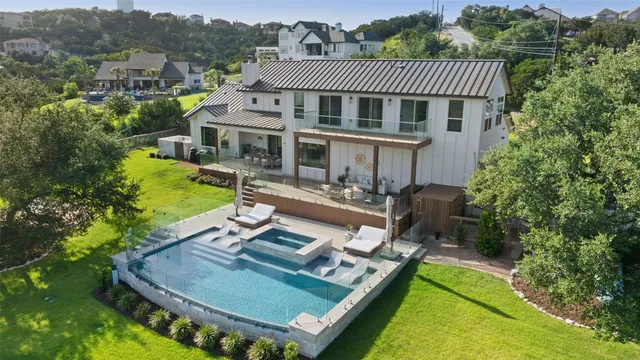 an aerial view of a house with swimming pool garden and patio