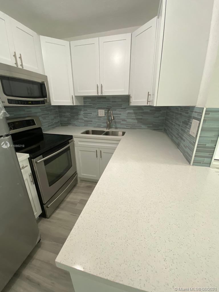 14801 Harding Lane Homestead, FL 33033 - Photo 14 of 26 a kitchen with stainless steel appliances a stove a microwave and cabinets