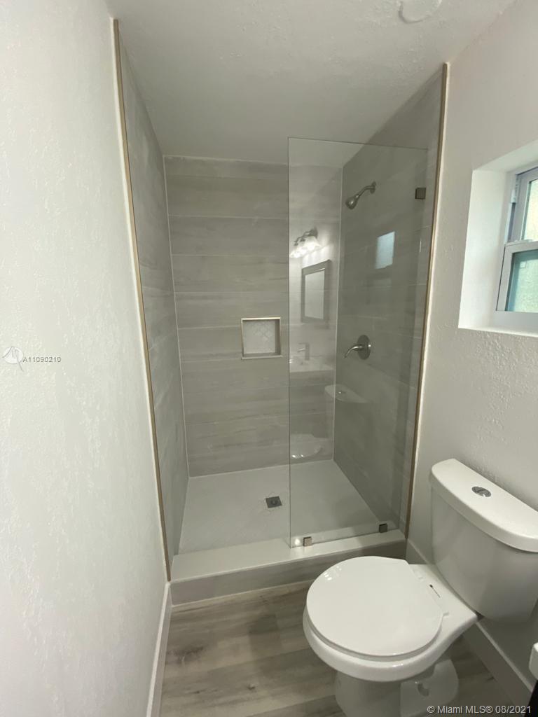 14801 Harding Lane Homestead, FL 33033 - Photo 22 of 26 a white toilet next to a bathroom sink