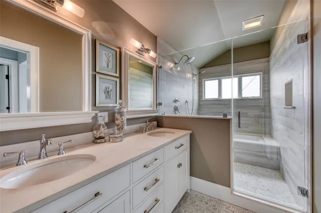 a bathroom with double sink and a mirror