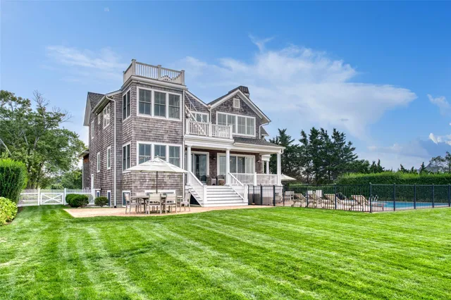 a front view of a house with a garden and sitting area