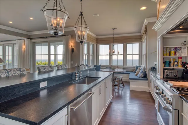 a large kitchen with stainless steel appliances lots of counter space and window