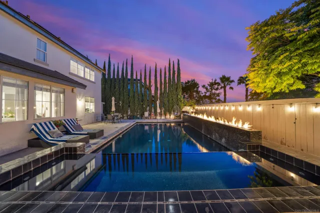 a view of a balcony with two couches and wooden floor