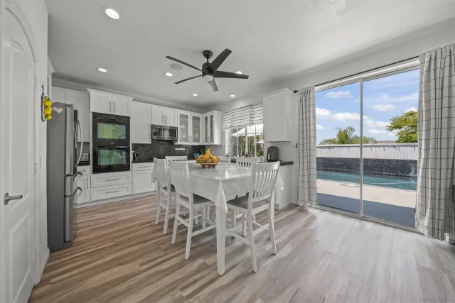 a kitchen with stainless steel appliances kitchen island granite countertop a sink and cabinets