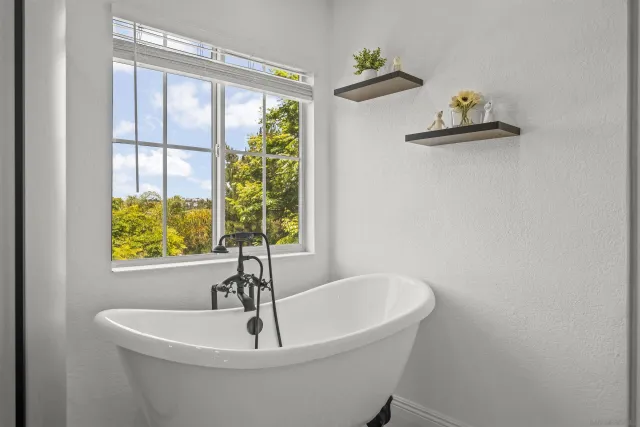 a living room with furniture a ceiling fan and a flat screen tv