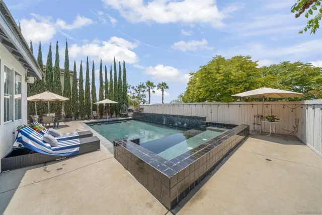 a view of swimming pool with chairs