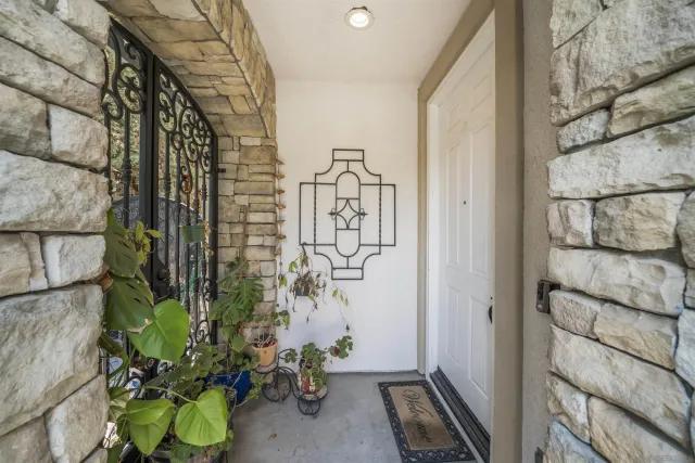 a dining room with wooden floor a chandelier a wooden table and chairs