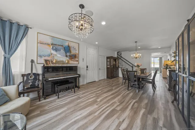 a view of a room with lots of wooden furniture and windows