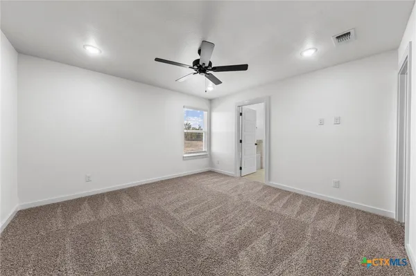 a view of a livingroom with a ceiling fan and window