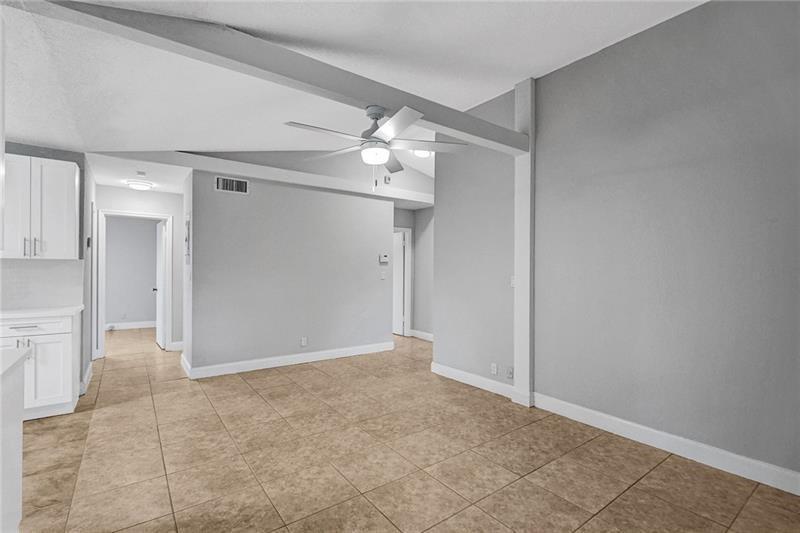 8221 Southwest 3rd Court Pompano Beach, FL 33068 - Photo 12 of 25 a view of a hallway with a chandelier fan and refrigerator