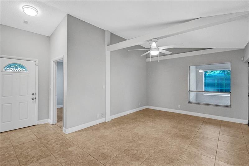 8221 Southwest 3rd Court Pompano Beach, FL 33068 - Photo 13 of 25 an empty room with windows and fan