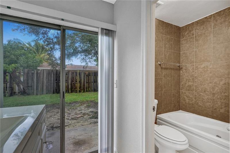8221 Southwest 3rd Court Pompano Beach, FL 33068 - Photo 20 of 25 a bathroom with a toilet and a shower