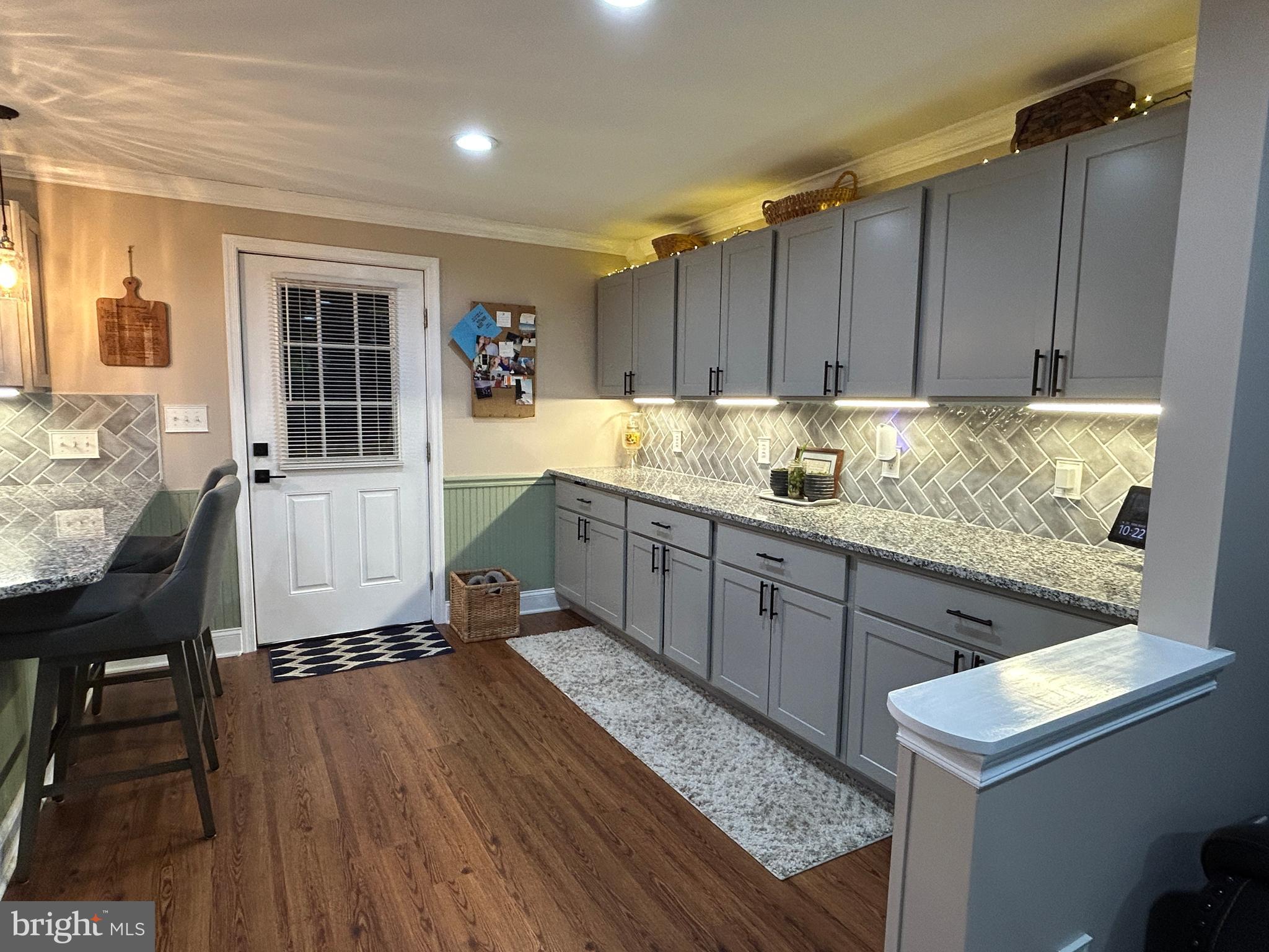 27002 Kaye Road Laurel, DE 19956 - Photo 16 of 64 a kitchen with sink cabinets and wooden floor
