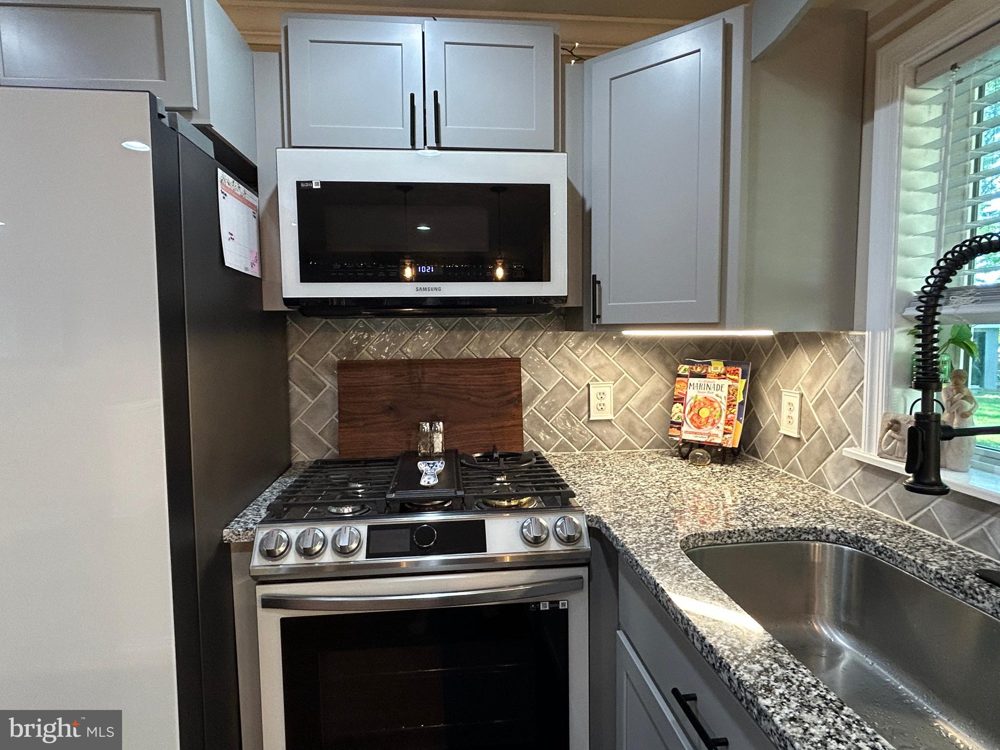 27002 Kaye Road Laurel, DE 19956 - Photo 23 of 64 a kitchen with granite countertop a stove and a sink