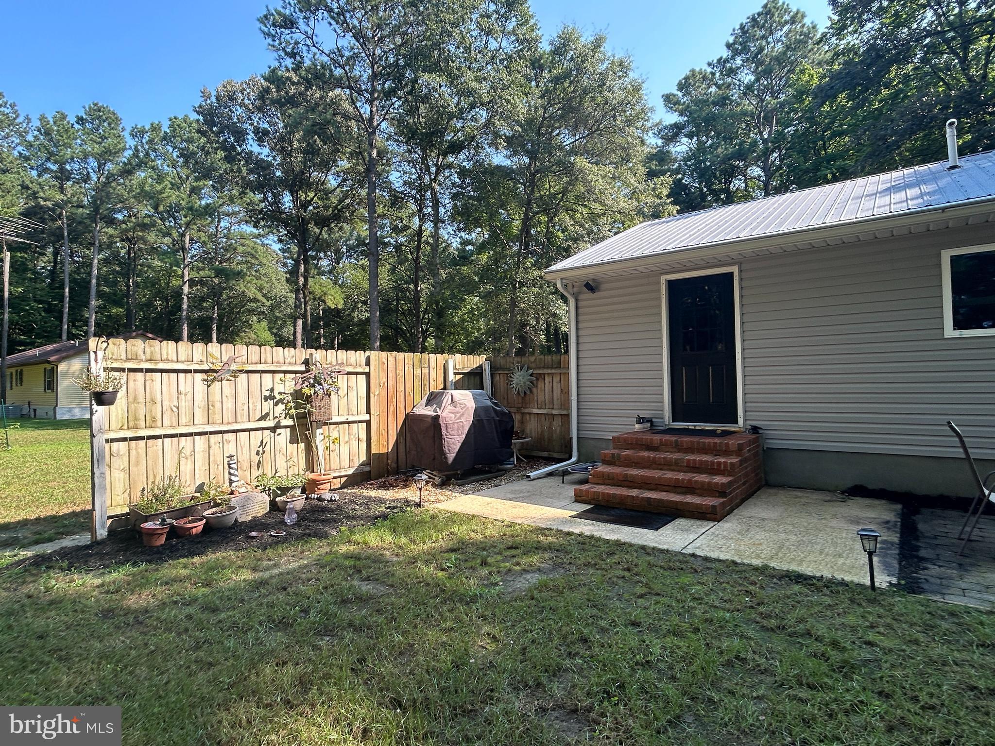 27002 Kaye Road Laurel, DE 19956 - Photo 45 of 64 a view of backyard with wooden fence and a bench