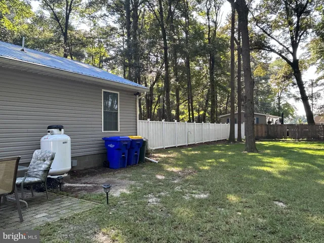 a view of backyard of house with seating space