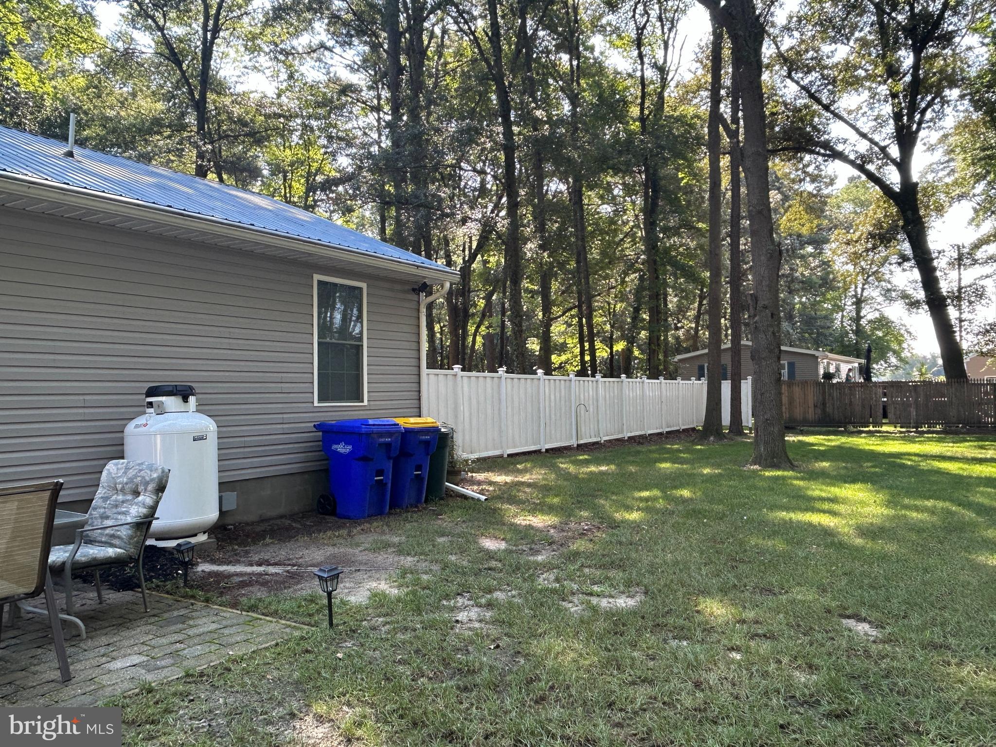 27002 Kaye Road Laurel, DE 19956 - Photo 48 of 64 a backyard of a house with wooden fence and large trees