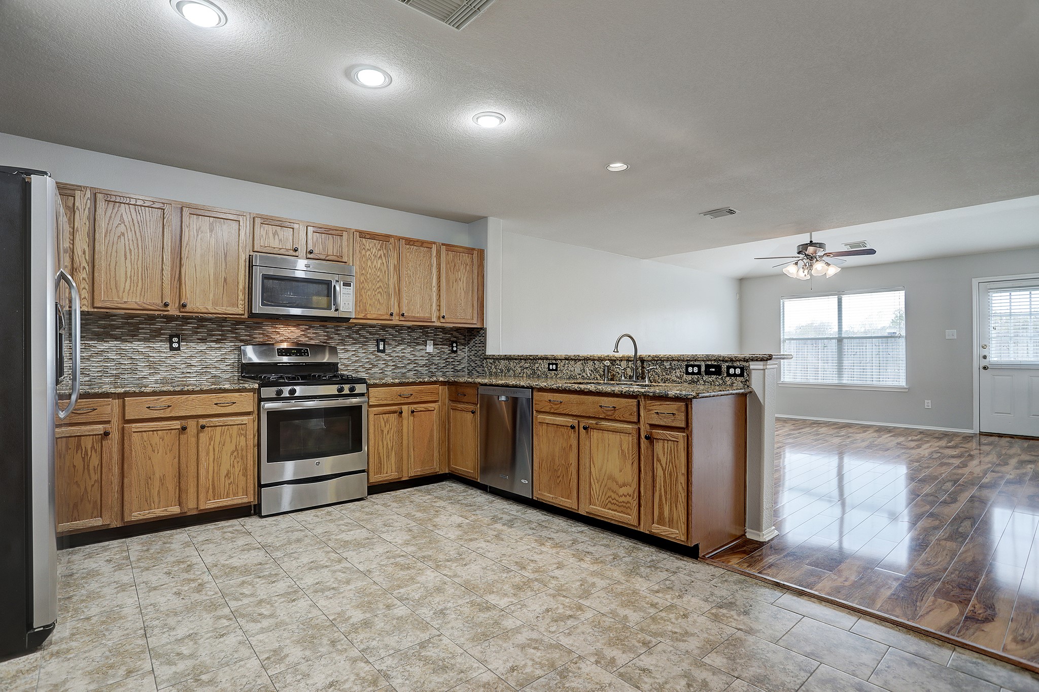 223 Sunset Colony Drive Rosharon, TX 77583 - Photo 12 of 45 Granite counters and tile flooring in the kitchen makes for easy cleanup.