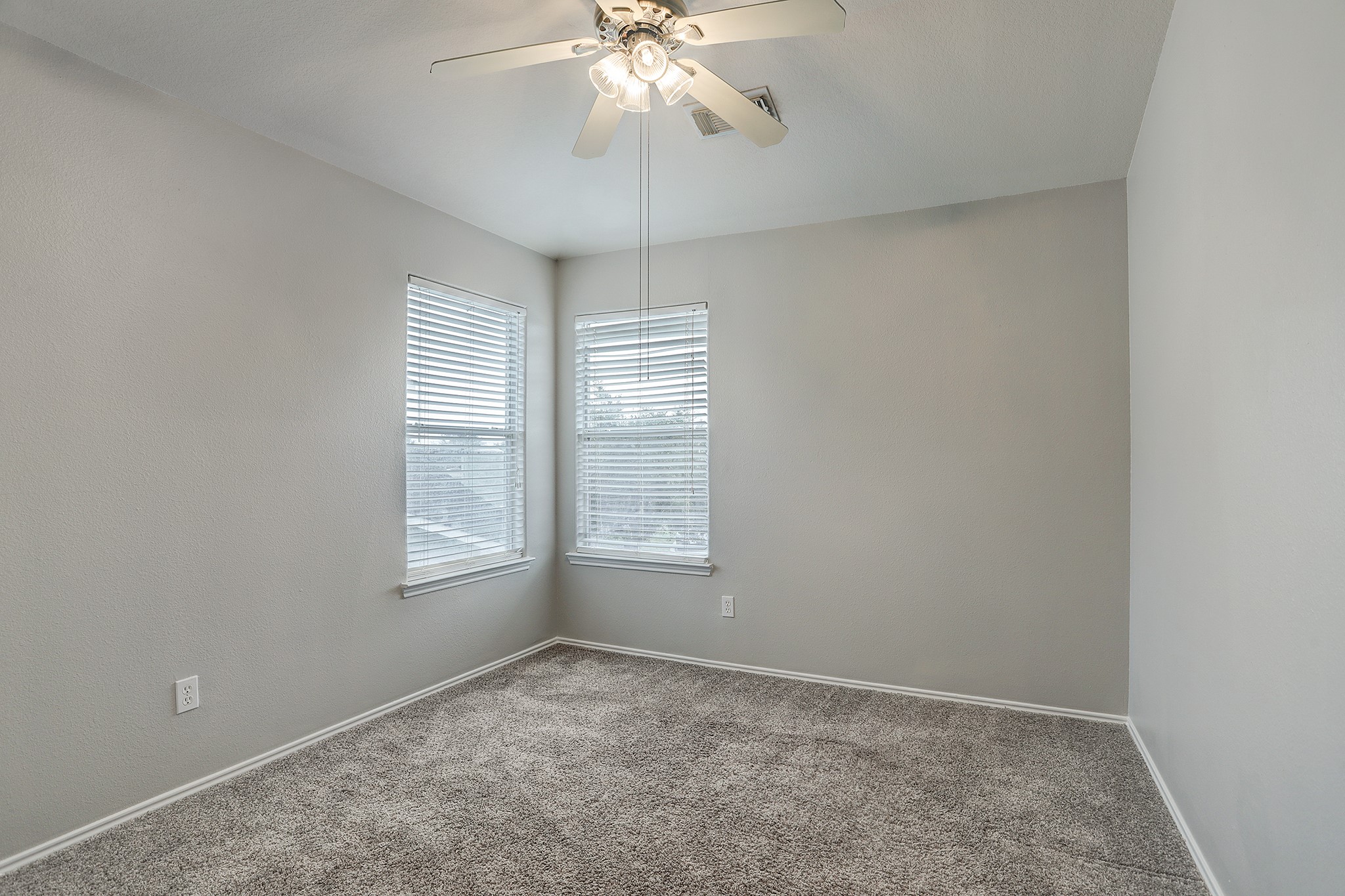 223 Sunset Colony Drive Rosharon, TX 77583 - Photo 29 of 45 The third upstairs bedroom shares features similar to the others. Ceiling fan, neutral colors and great natural light.