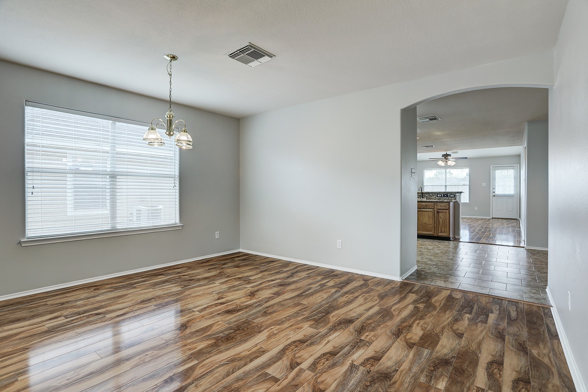 223 Sunset Colony Drive Rosharon, TX 77583 - Photo 7 of 45 Gorgeous laminate floors in the dining area. View the living room and kitchen as well. This light fixture has been swapped out.