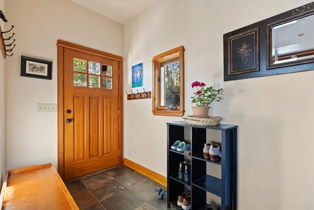 a view of an entryway with wooden floor