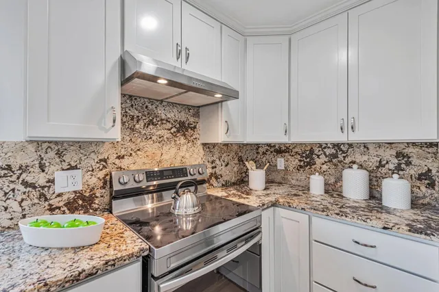 a kitchen with a sink and wooden floor