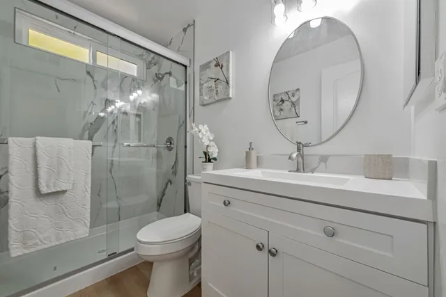 a bathroom with a toilet sink and mirror