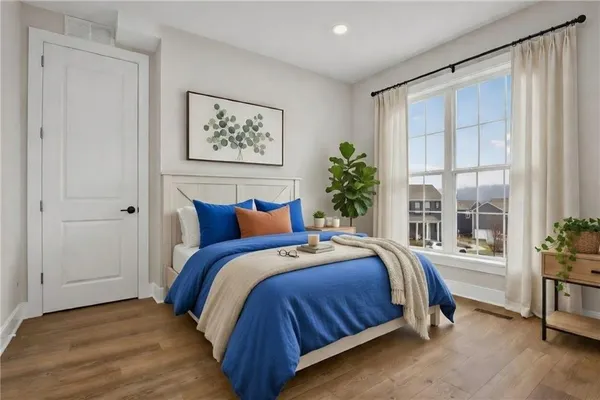 a bedroom with bed and a large window