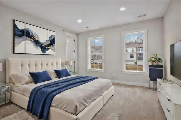 a spacious bedroom with a large bed and a window