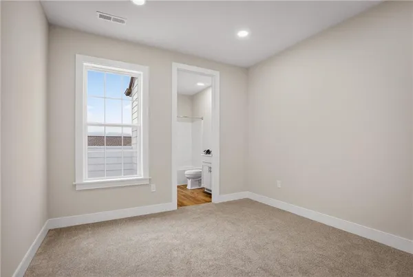 a bedroom with a large bed and a flat screen tv