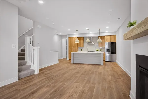 a view of a kitchen with a sink and a refrigerator