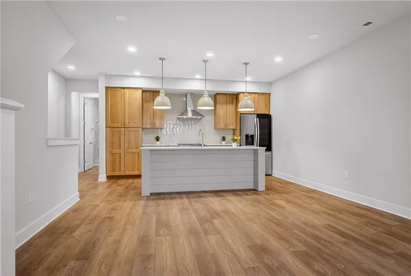 a large kitchen with kitchen island a island in the center