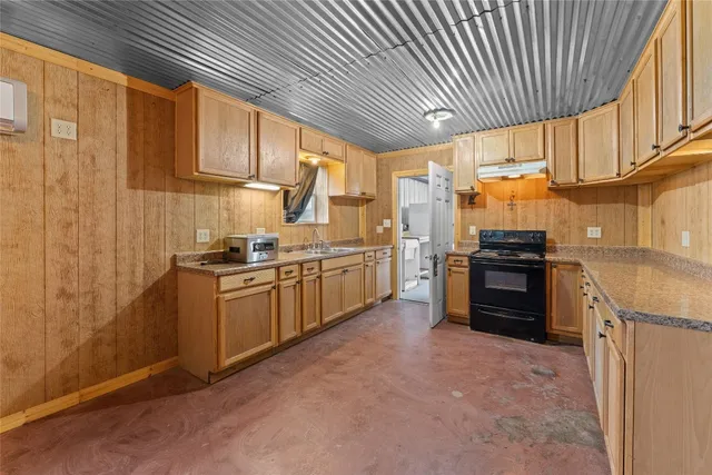 a kitchen with stainless steel appliances granite countertop a stove sink and cabinets