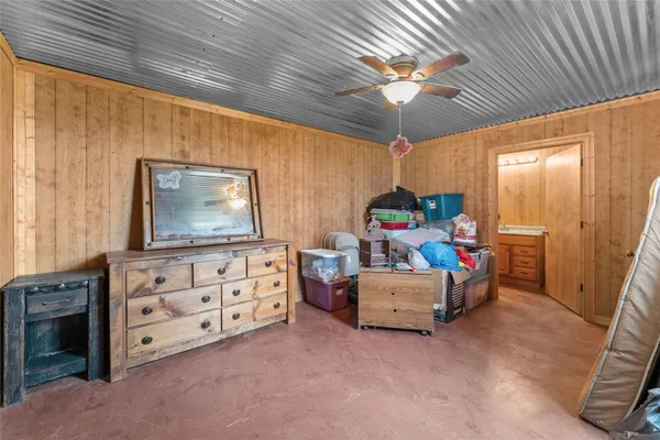 a bedroom with furniture and a flat screen tv