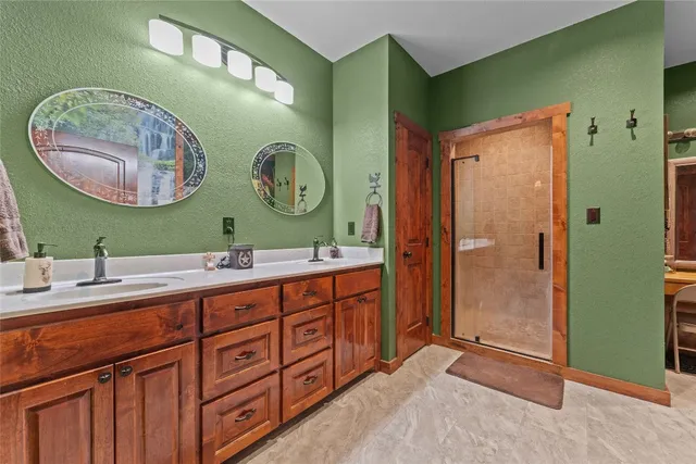 a bathroom with a double vanity sink and a mirror
