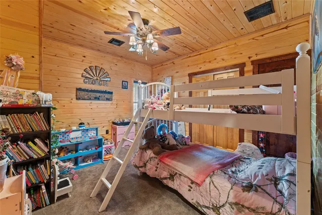 a bed room with a bed and a bookshelf