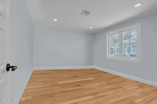 a bedroom with two beds and a flat screen tv