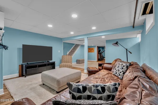 a bedroom with furniture and wooden floor