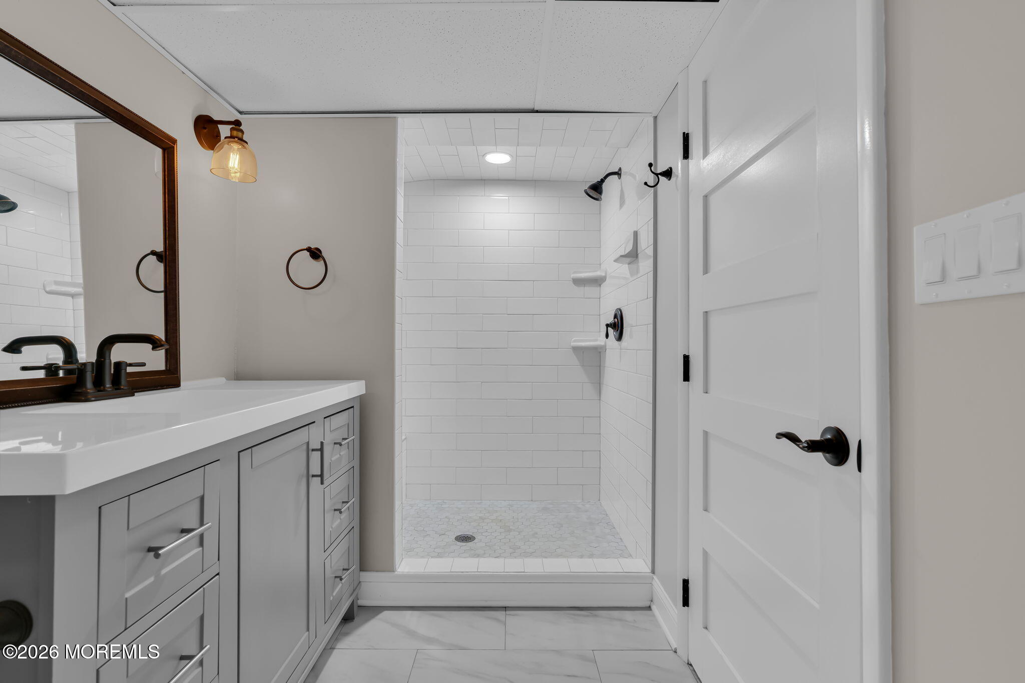2 Tulip Tree Lane Rumson, NJ 07760 - Photo 45 of 55 a bathroom with a shower sink and mirror