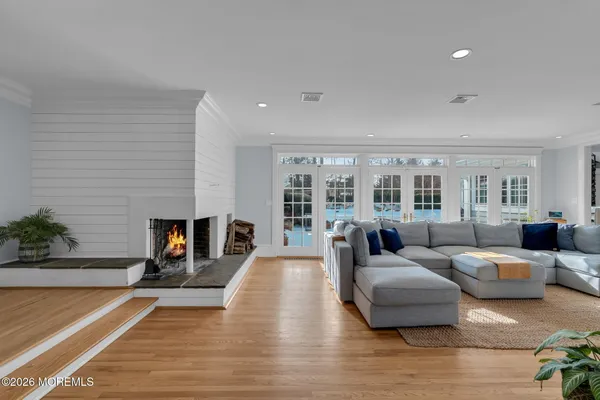 a living room with furniture a flat screen tv and a floor to ceiling window