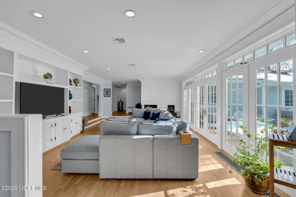 a view of a hallway with wooden floor and furniture