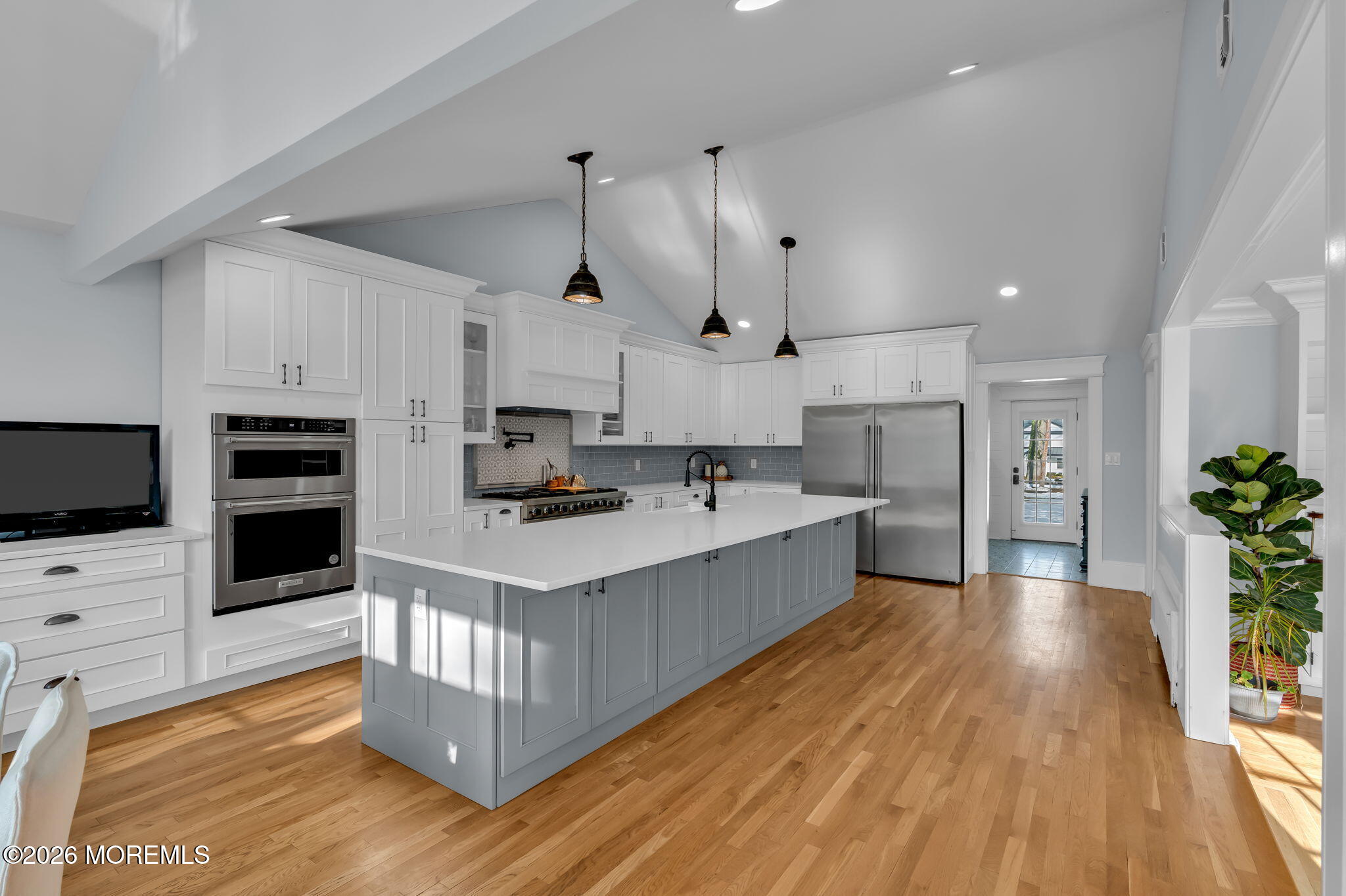 2 Tulip Tree Lane Rumson, NJ 07760 - Photo 10 of 55 a kitchen with stainless steel appliances a stove top oven a sink dishwasher and a refrigerator with wooden floor