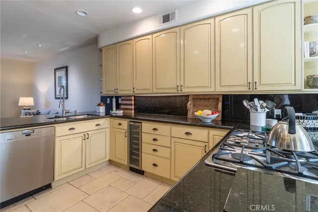 a kitchen with stainless steel appliances granite countertop a sink stove and cabinets